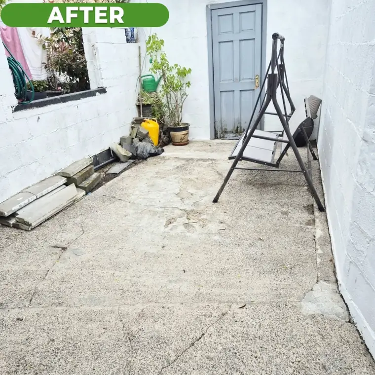 The same concrete yard after cleaning, clear and washed down.