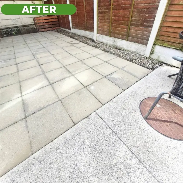 The same patio slabs after cleaning, pale grey and clear of algae.