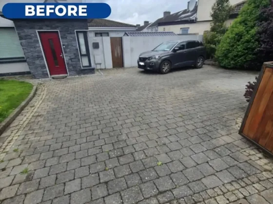 The same driveway before the clean, dark and marked with moss and dirt.