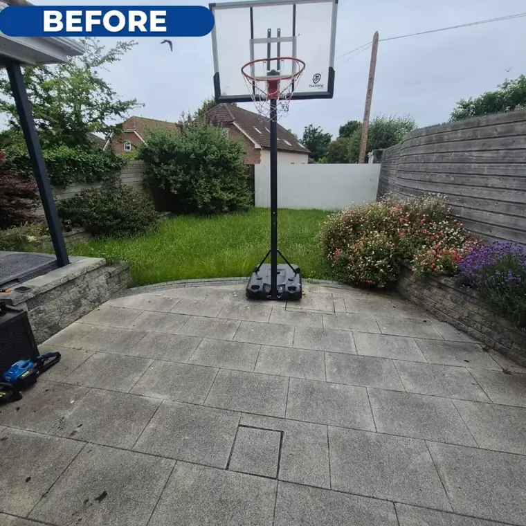 Rear slab yard before cleaning, patchy and grey with dirt.