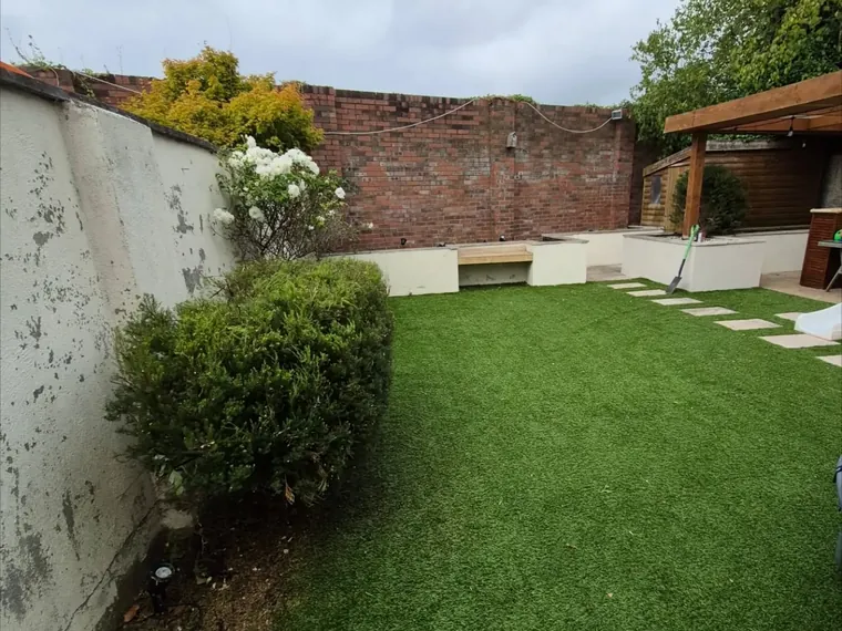 Garden after a tidy-up, lawn cut short and borders cleared.